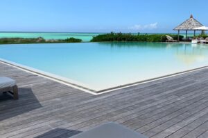 View of recliner, ipe deck, and infinity pool